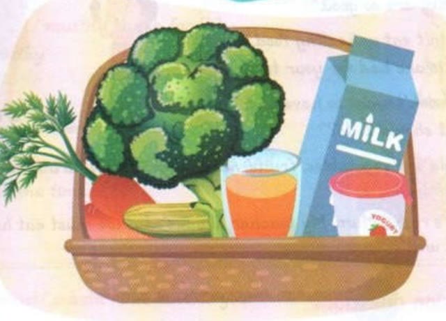 A basket with broccoli, carrots, a cucumber, orange juice, milk and yogurt